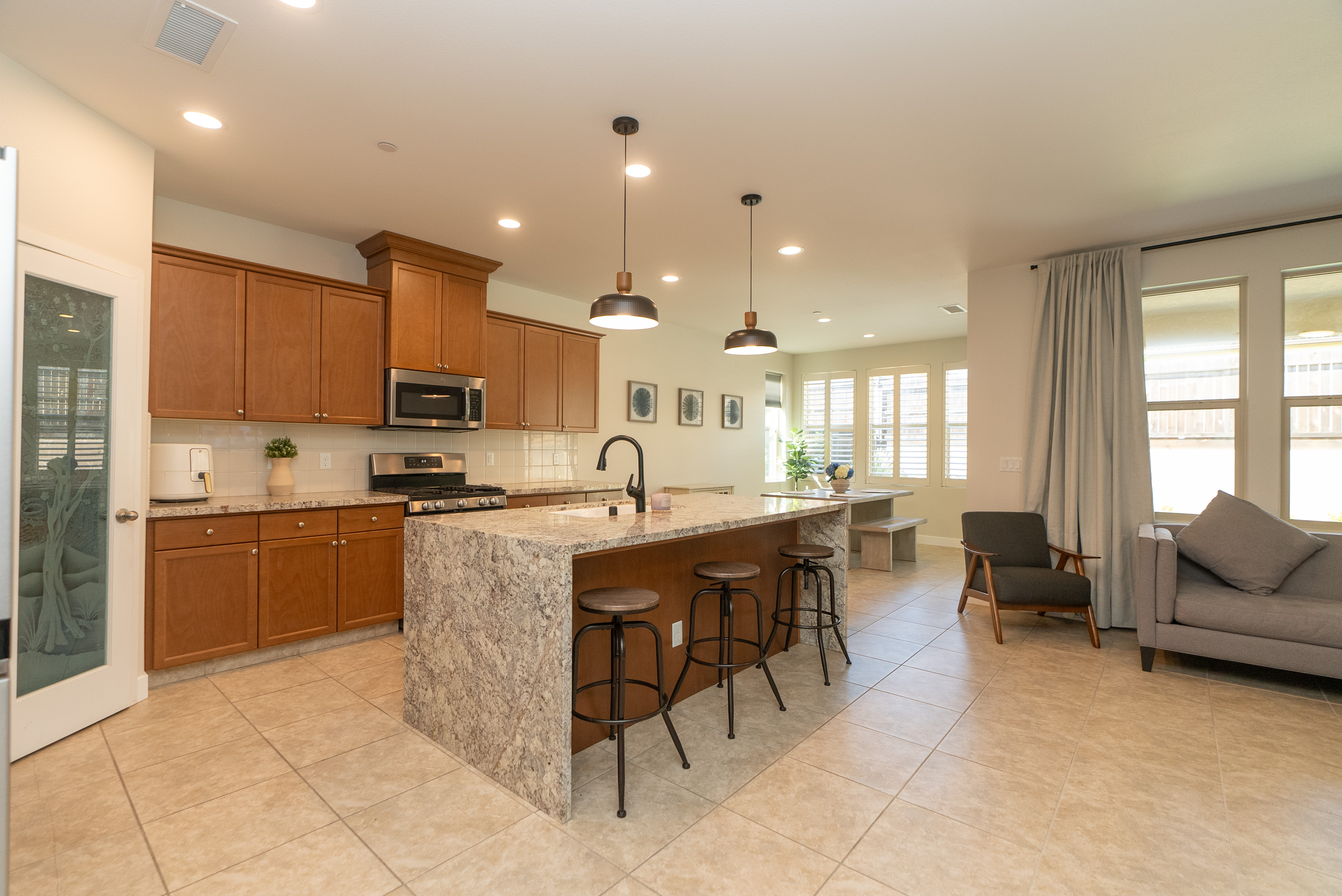 Bright kitchen with island and pendant lights